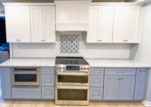  Blue Cabinets White Cabinets Nickel Knobs And Pulls Stainless Steel Appliances White Glossy Tile Backsplash Hand Painted Dutch Tile Kitchen Remodel dRemodeling