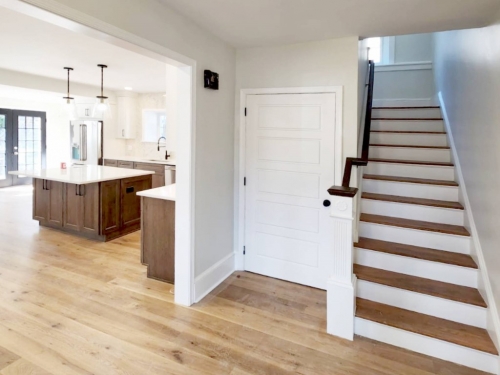 earthy wood white transitional kitchen stair relocation